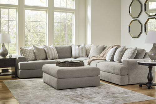 Dark gray sectional sofa set with chaise, ottoman, and striped throw pillows