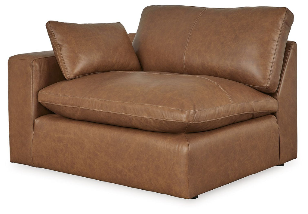 Caramel brown faux leather armchair with padded arms, seat, and two back cushions.