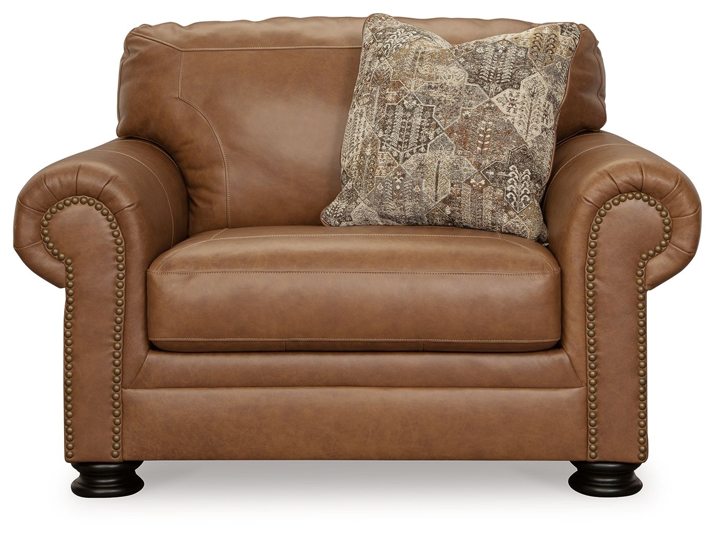 Caramel chair and a half with rolled arms, nailhead trim, and square patterned pillow