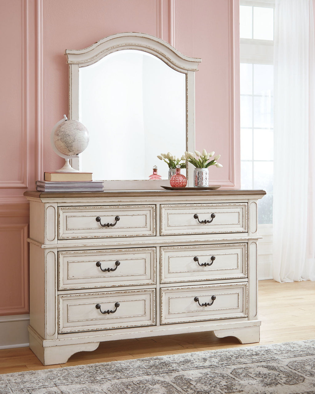 White dresser with mirror and six drawers, decorative frame and curved skirt base.