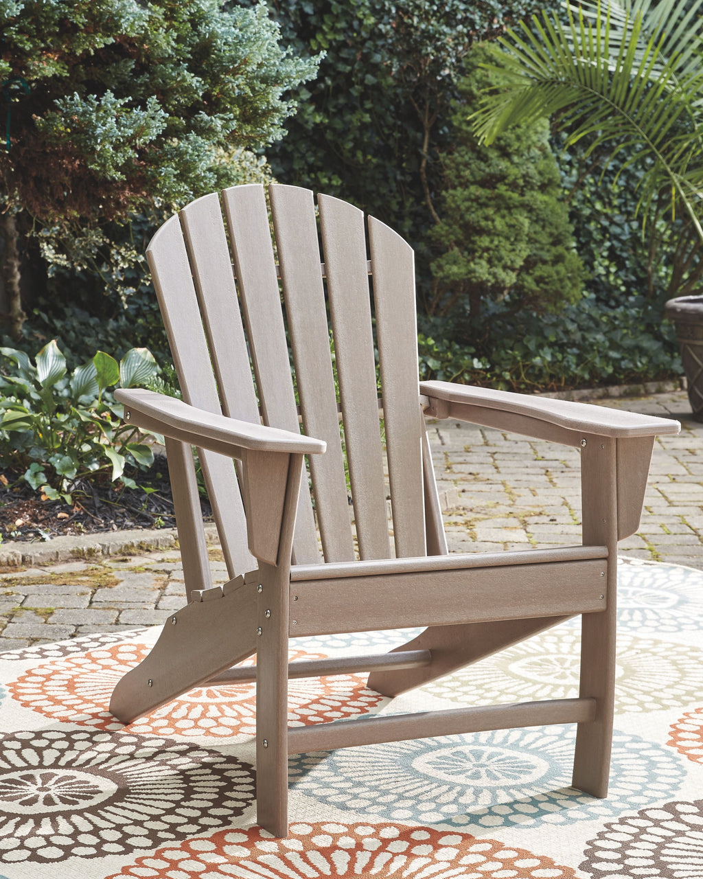 White Adirondack armchair with wide arms and slatted back and seat