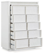 White five-drawer chest shown from the side with drawers partially pulled out