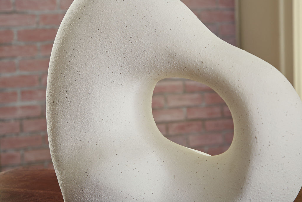 Off-white abstract sculpture with teardrop form and oval opening