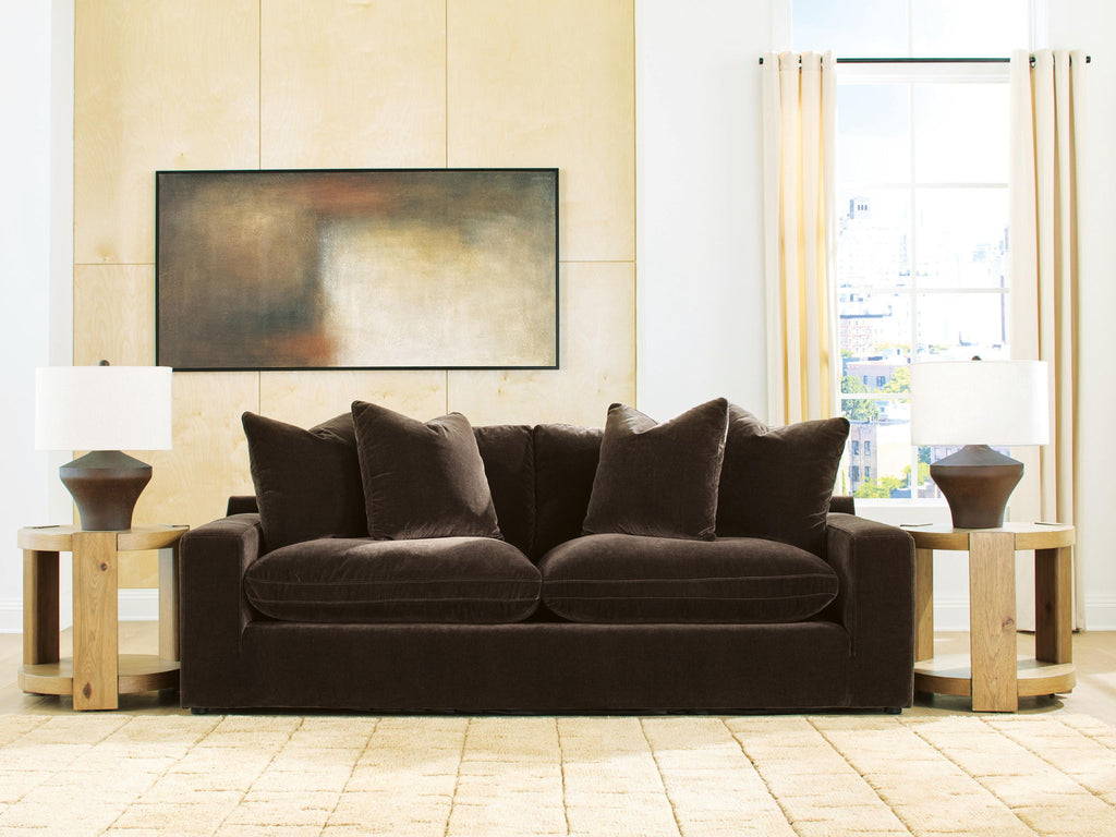 Dark brown fabric sofa with rounded seat and five back pillows, low profile