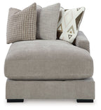 Pebble gray chaise seat with large textured and patterned throw pillows