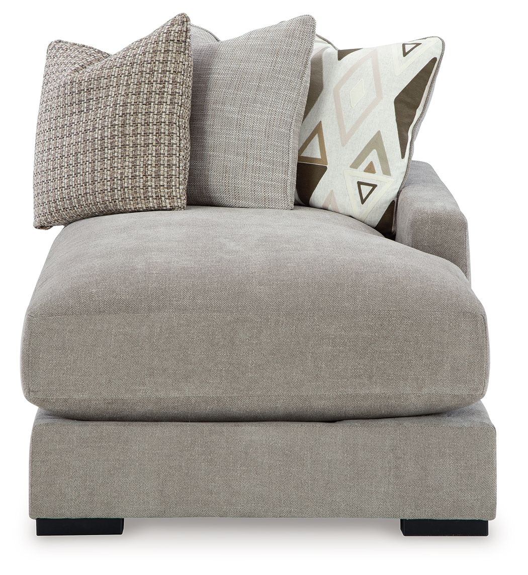 Pebble gray chaise seat with large textured and patterned throw pillows