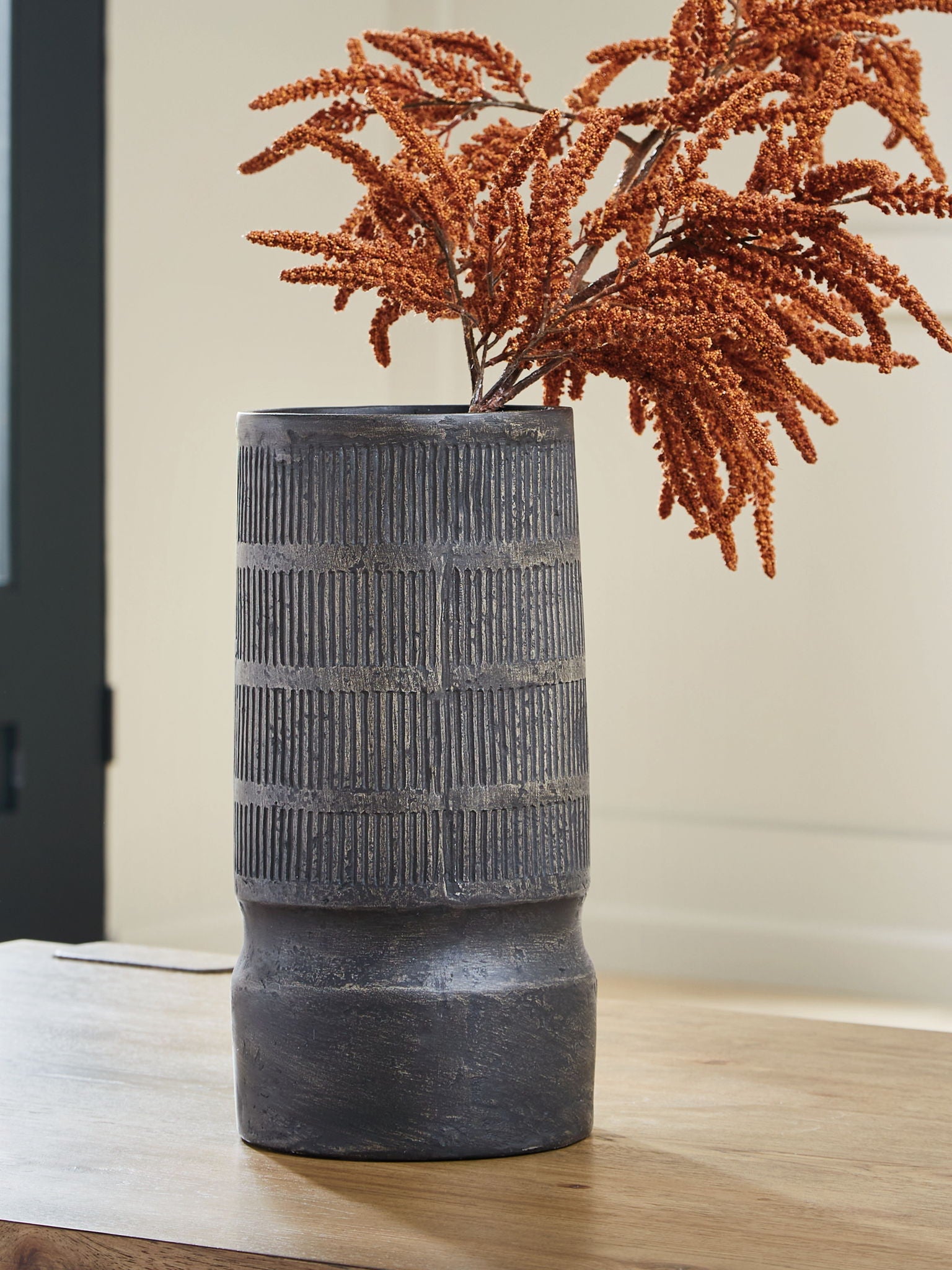 Beninworth vase, black ribbed cylinder with rounded pedestal base.