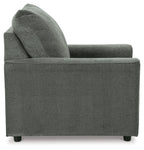 Gray upholstered armchair side view with high backrest and thick seat cushion