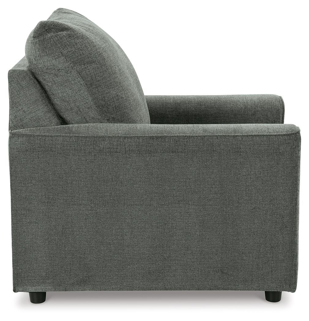 Gray upholstered armchair side view with high backrest and thick seat cushion