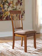 Rustic brown dining side chair with slat back and upholstered seat, viewed from side