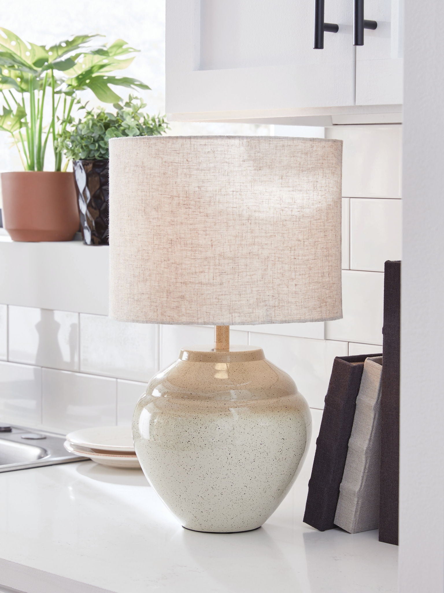 Cream beige table lamp with drum fabric shade and textured speckled ceramic body