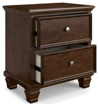 Brown two-drawer nightstand showing side panel and round metal knobs