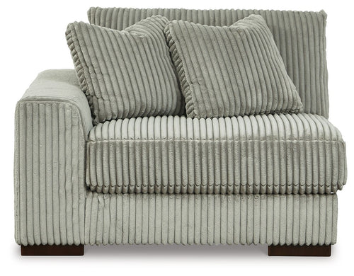 Fog gray corduroy corner chair with tufted seat front and three back pillows