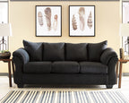 Black sofa with three seat cushions and padded rolled arms, centered view
