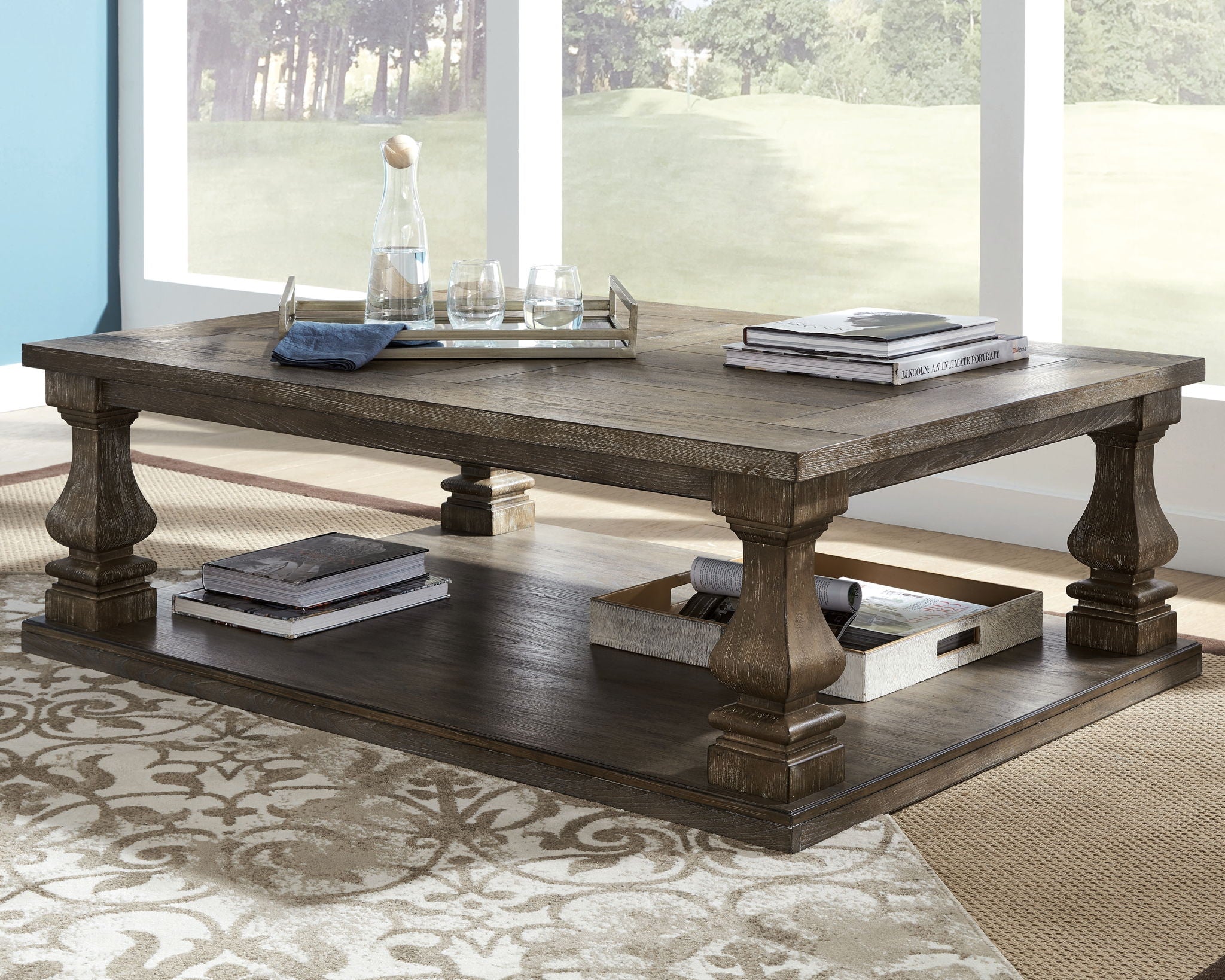 Gray rectangular cocktail table with lower shelf and sturdy turned legs