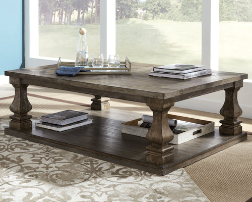 Gray rectangular cocktail table with lower shelf and sturdy turned legs