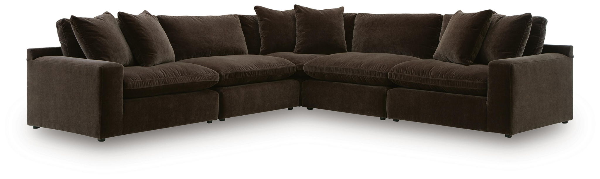 Dark brown L-shaped sectional sofa with tufted-look seat cushions and layered back pillows.