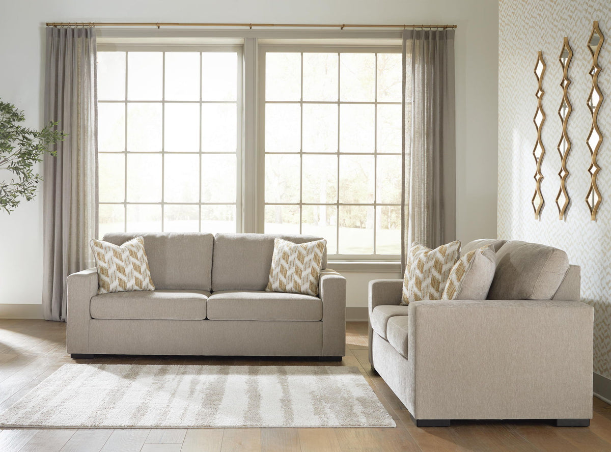 Living room set: light gray sofa and loveseat with patterned pillows