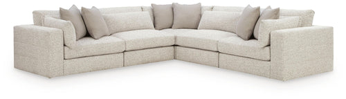 Beige U-shaped sectional sofa with corner and chaise lounge, padded arms and throw pillows