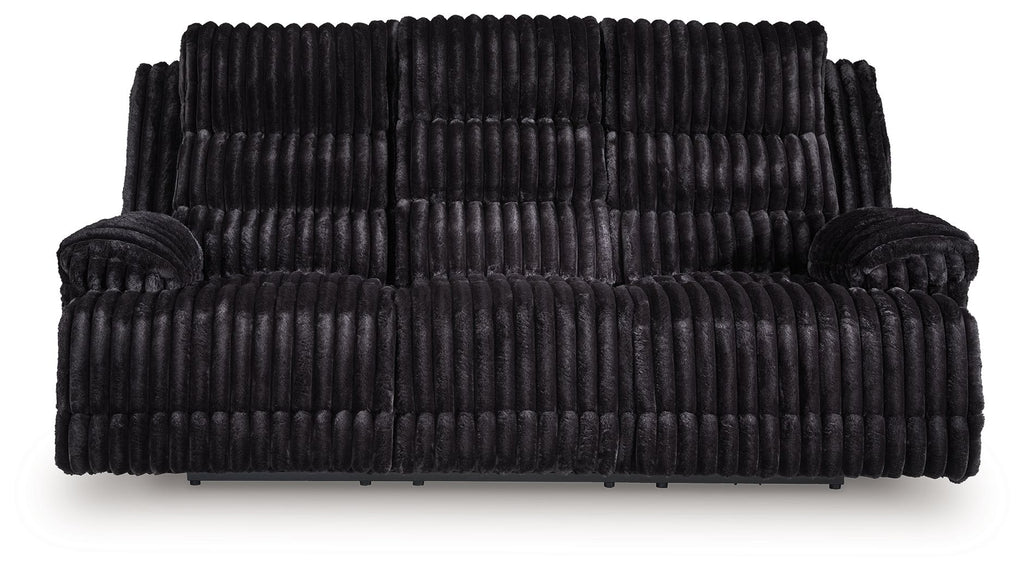 Black corduroy reclining sofa with padded arms and segmented seat back cushions