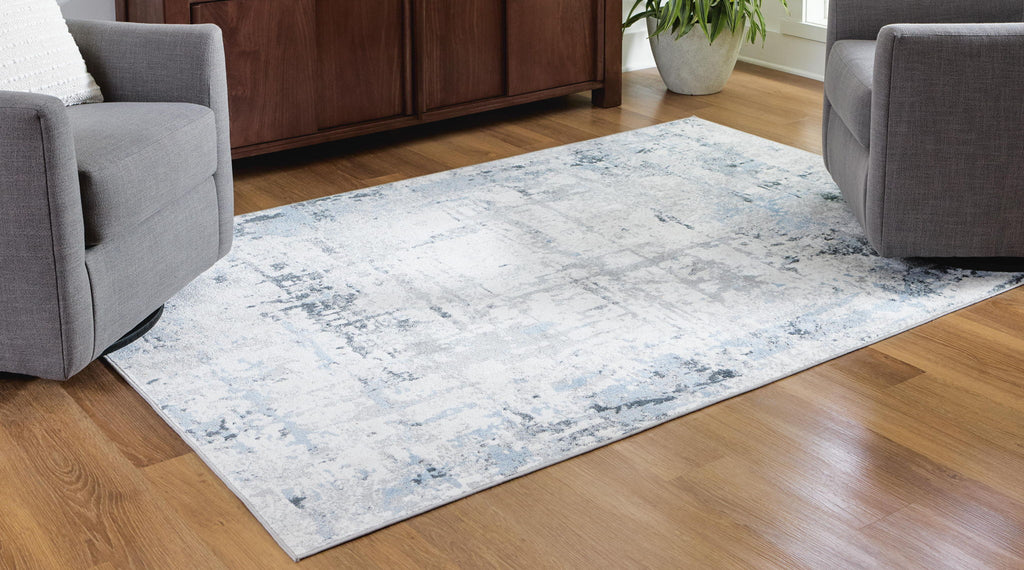 Light blue washable rug with distressed abstract pattern on low pile