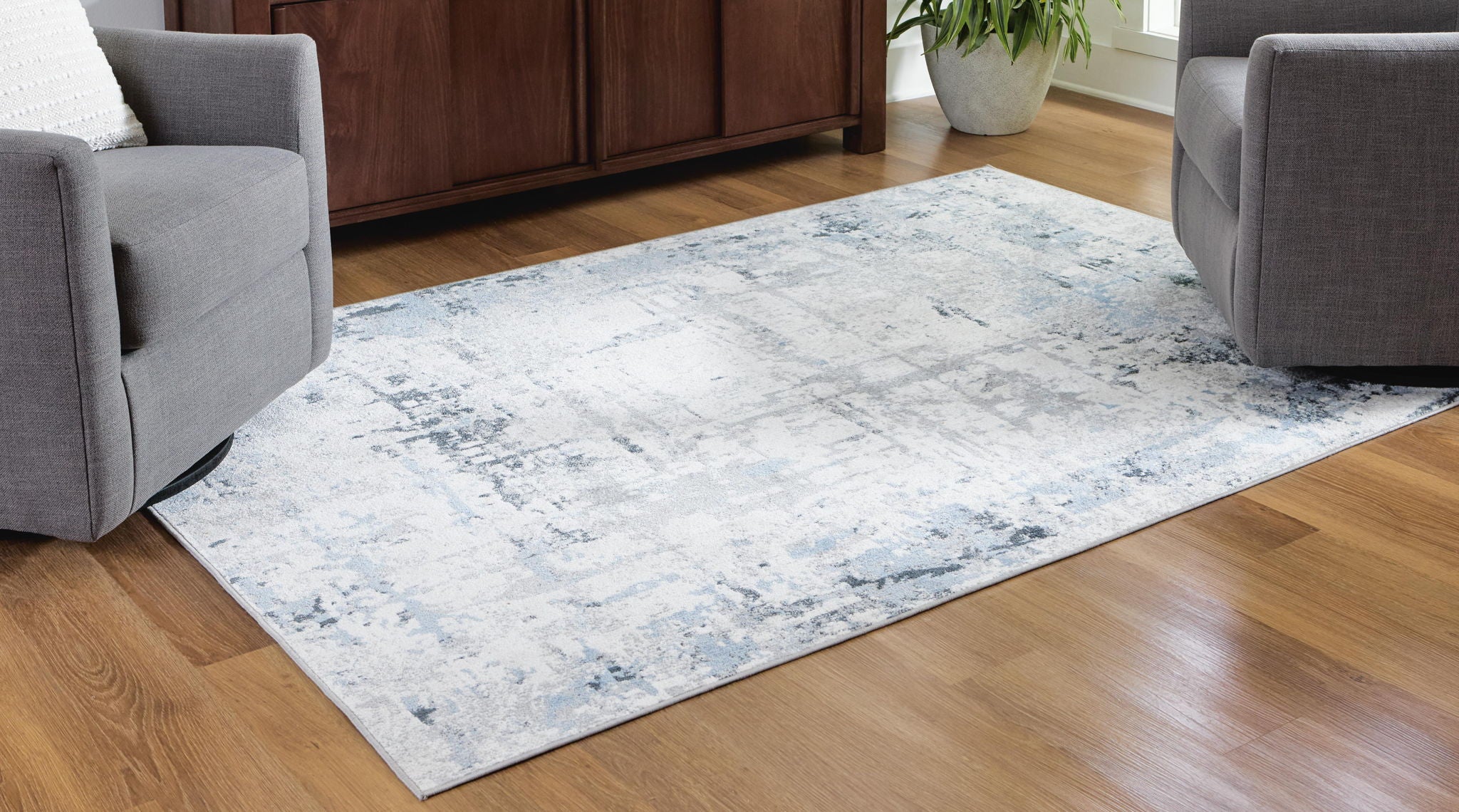 Light blue washable rug with distressed abstract pattern on low pile