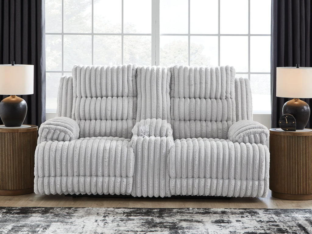 White channel-tufted double reclining loveseat with central headrest and padded arm seats