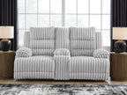 White channel-tufted double reclining loveseat with central headrest and padded arm seats