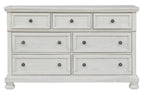 Antique white dresser with six drawers and round knob pulls, three top and three bottom.