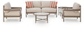 Beige patio furniture set with loveseat, two lounge chairs, and two round side tables