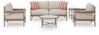 Beige patio furniture set with loveseat, two lounge chairs, and two round side tables