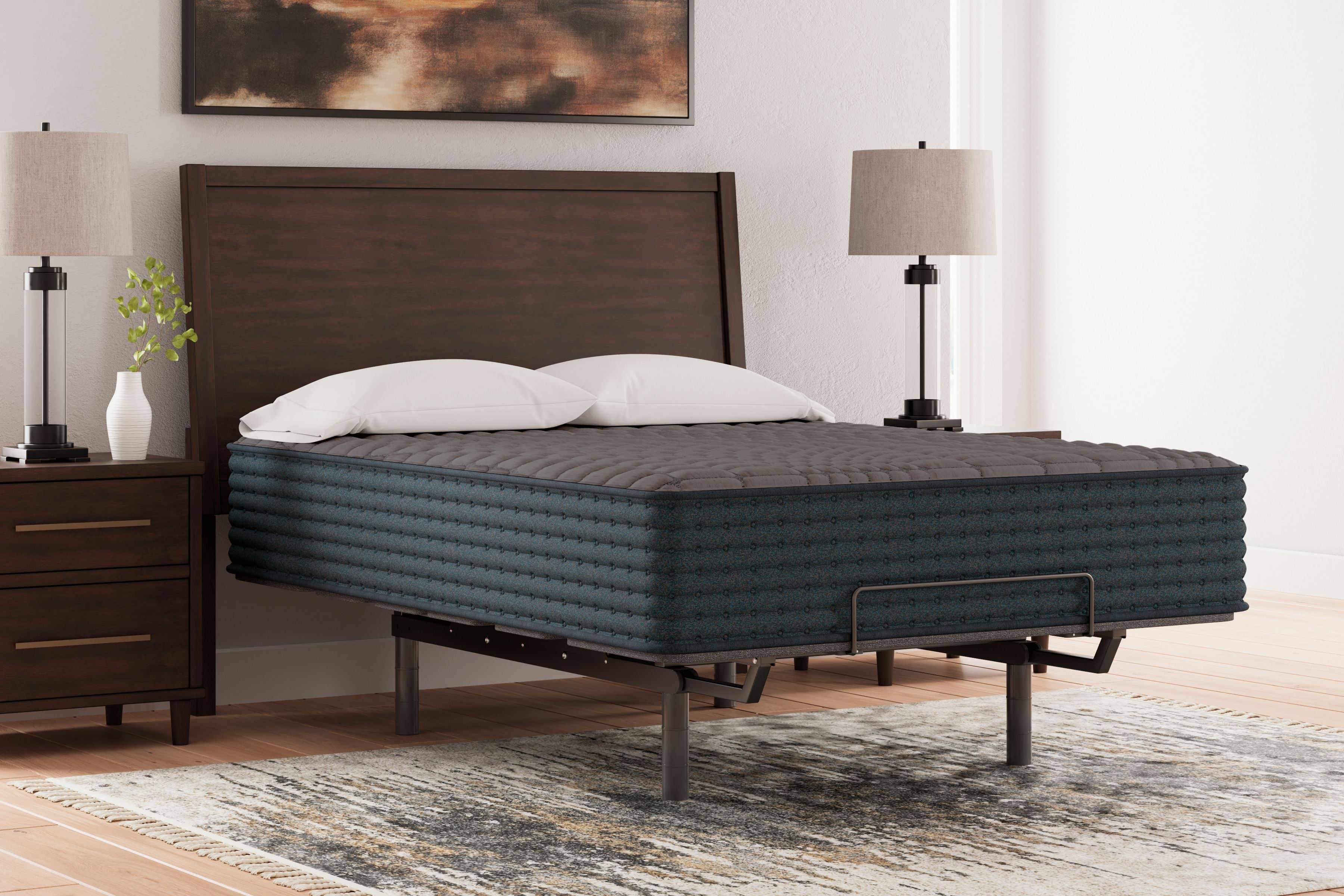 Gray hybrid mattress on a dark bed frame, quilted top and side edge