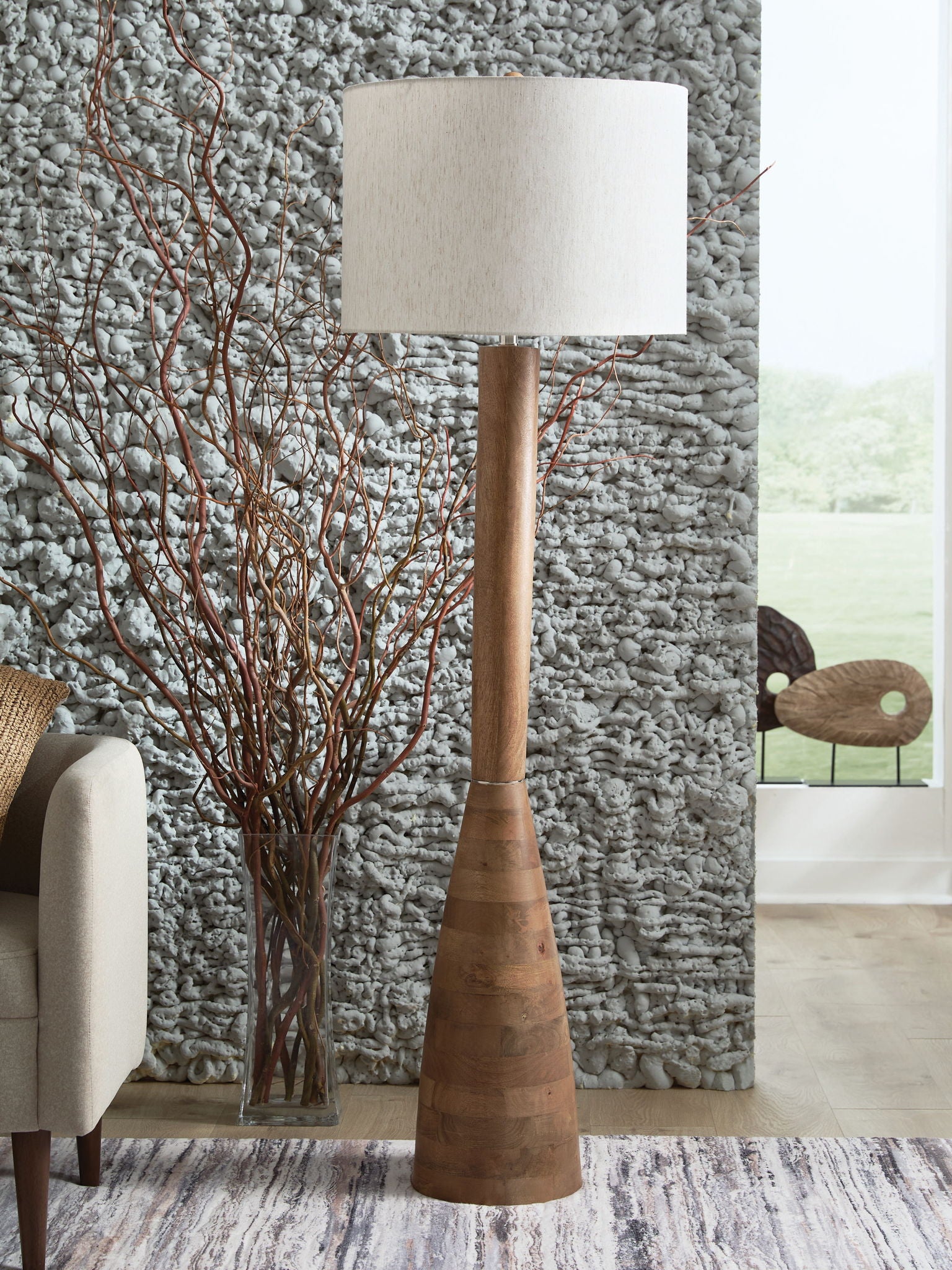 Wood floor lamp with tall natural brown wooden base and white fabric shade