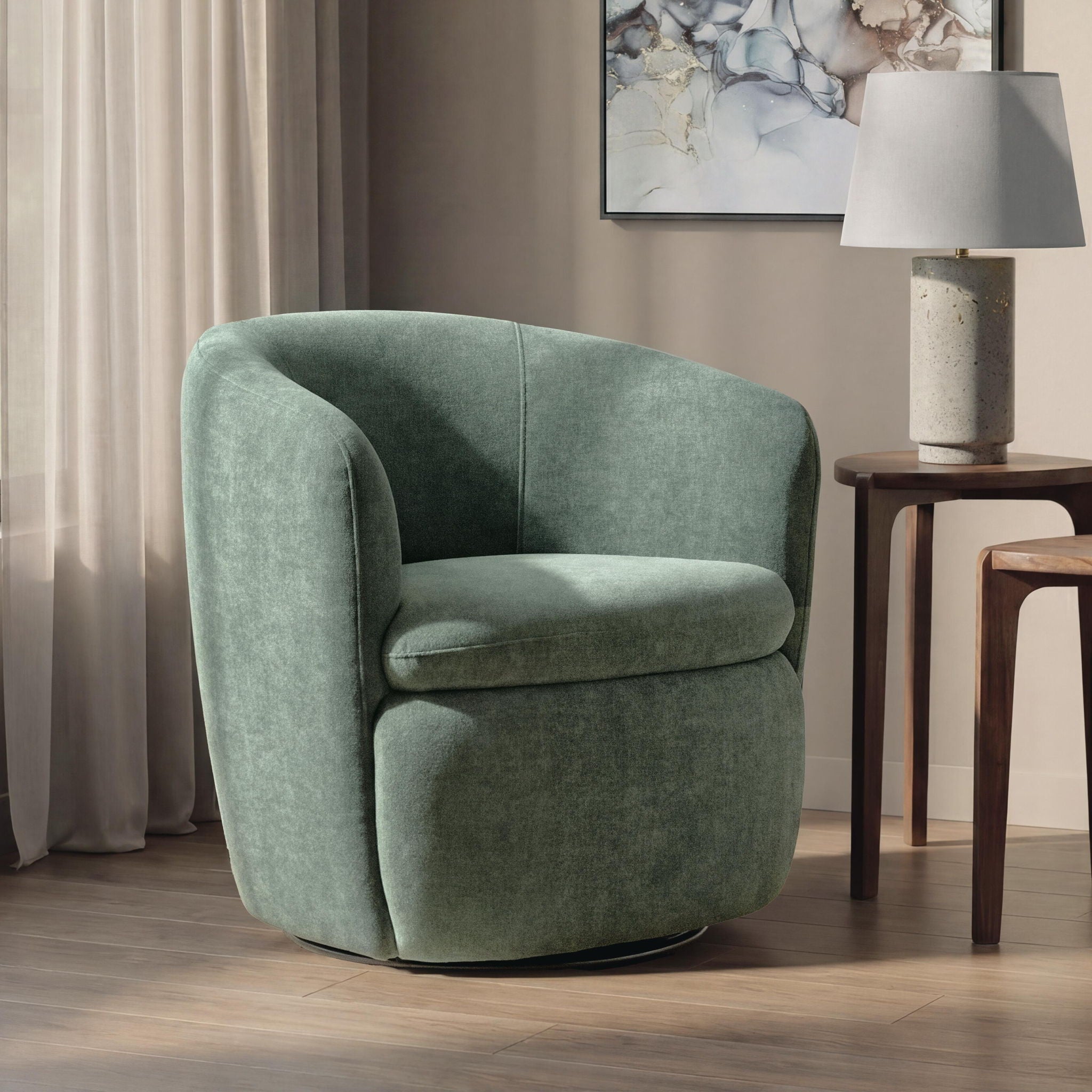 Swivel accent chair in green velvet with rounded arms and contoured seat cushion.
