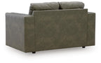 Olive green loveseat viewed from side, with wide arms and two-seat cushion