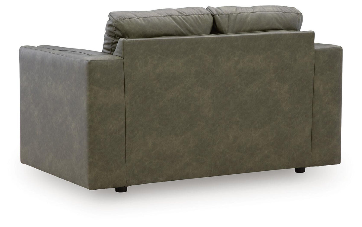Olive green loveseat viewed from side, with wide arms and two-seat cushion