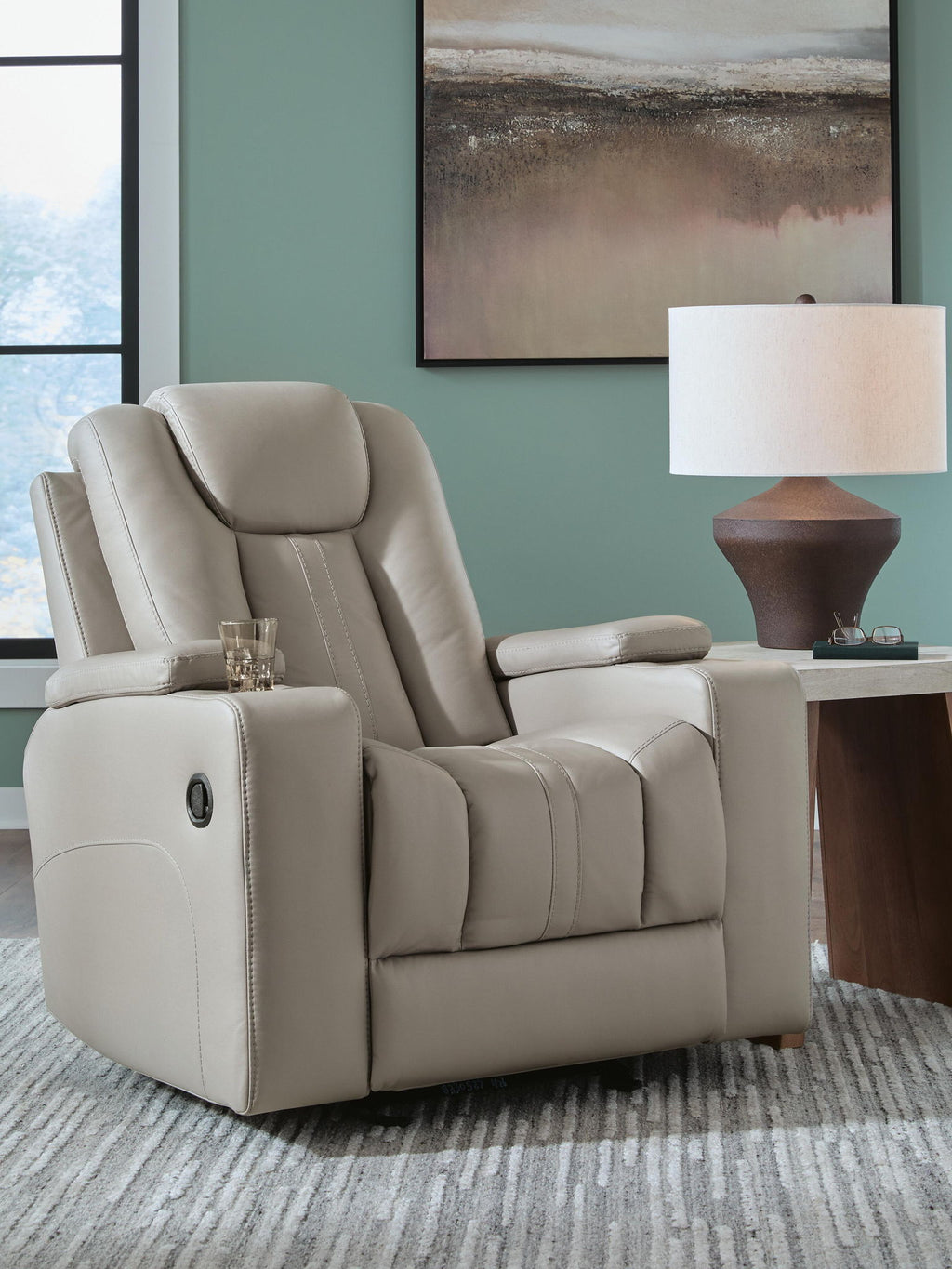 Light gray leather recliner chair with tall headrest, cushioned arms, and reclined seat