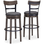 Gray upholstered tall swivel barstool with dark wood legs and round footrest