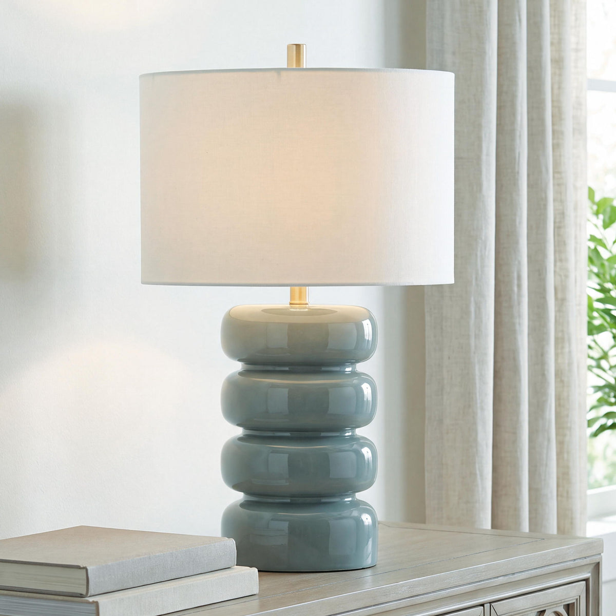 Ceramic table lamp with white shade and gray-blue ceramic base on table
