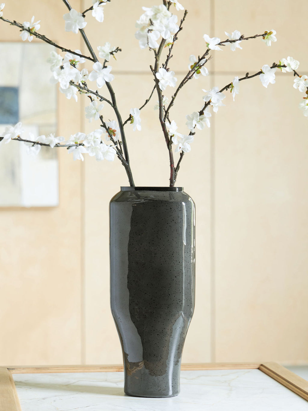 Dark speckled ceramic vase with glossy finish and flared open top