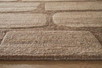 Brown and beige textured rug pile with stitched edge binding