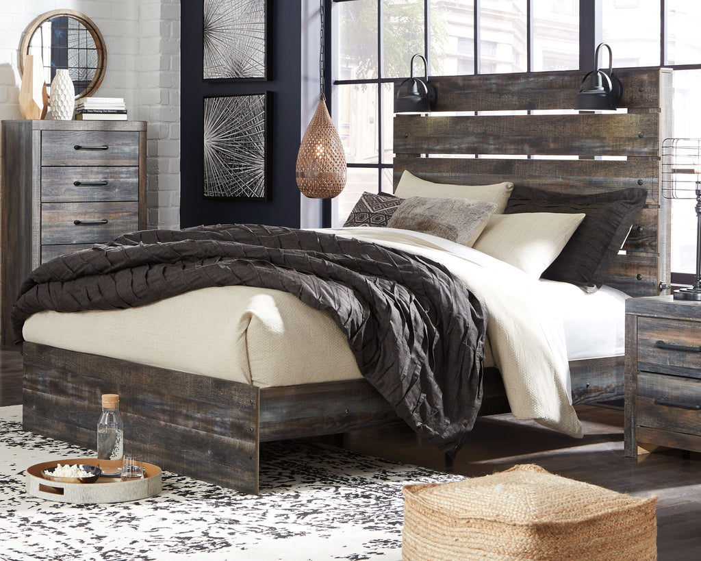 Panel bed with dark distressed wood frame and slat headboard; bed skirt and pillows shown