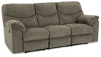 Reclining sofa with dark gray upholstery and thick seat cushions; rolled arms and back.