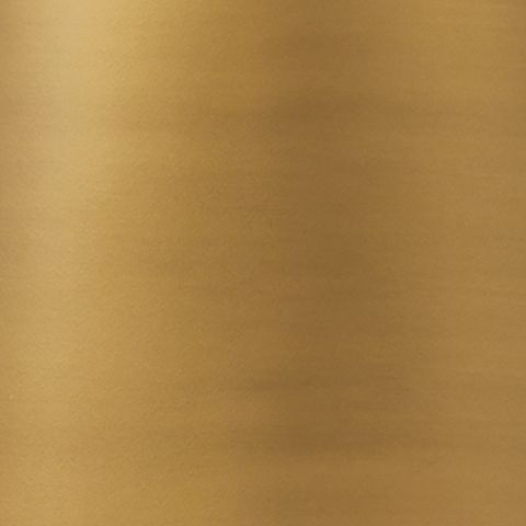 Gold metal lamp surface close-up with brushed finish texture