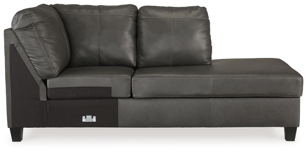 Dark gray leather corner chaise with two back pillows, track arms, and square wooden legs.