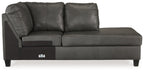 Dark gray leather corner chaise with two back pillows, track arms, and square wooden legs.