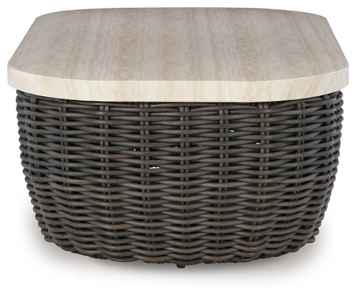 Beige tabletop on dark brown wicker cocktail table with rounded corners