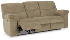 Reclining sofa with beige upholstery; rolled armrests and extended footrest mechanism visible.