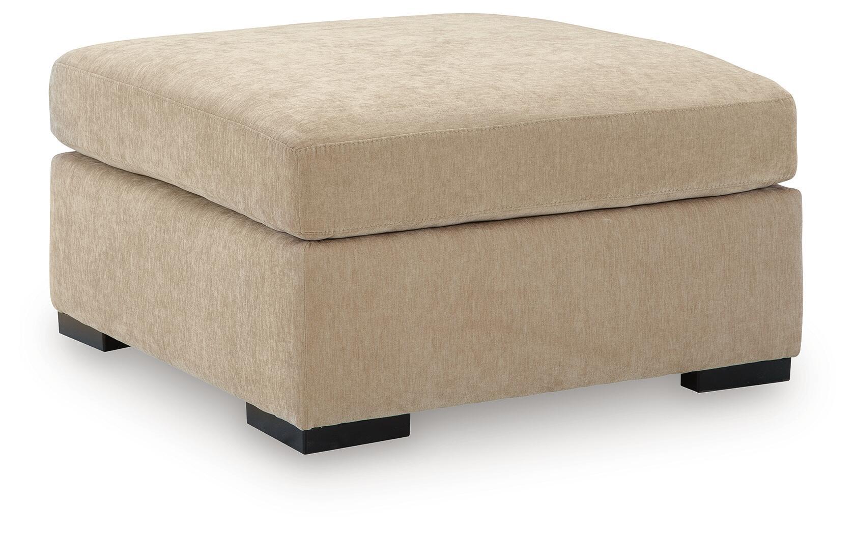 Light brown upholstered oversized accent ottoman with rounded top and black feet