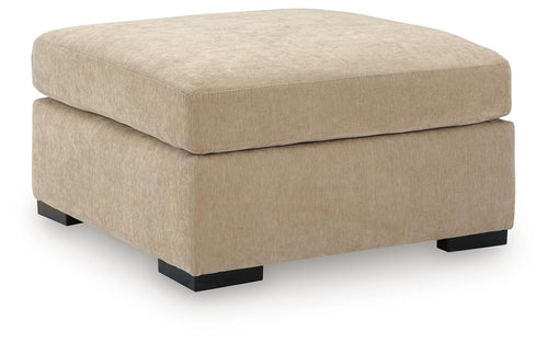 Light brown upholstered oversized accent ottoman with rounded top and black feet